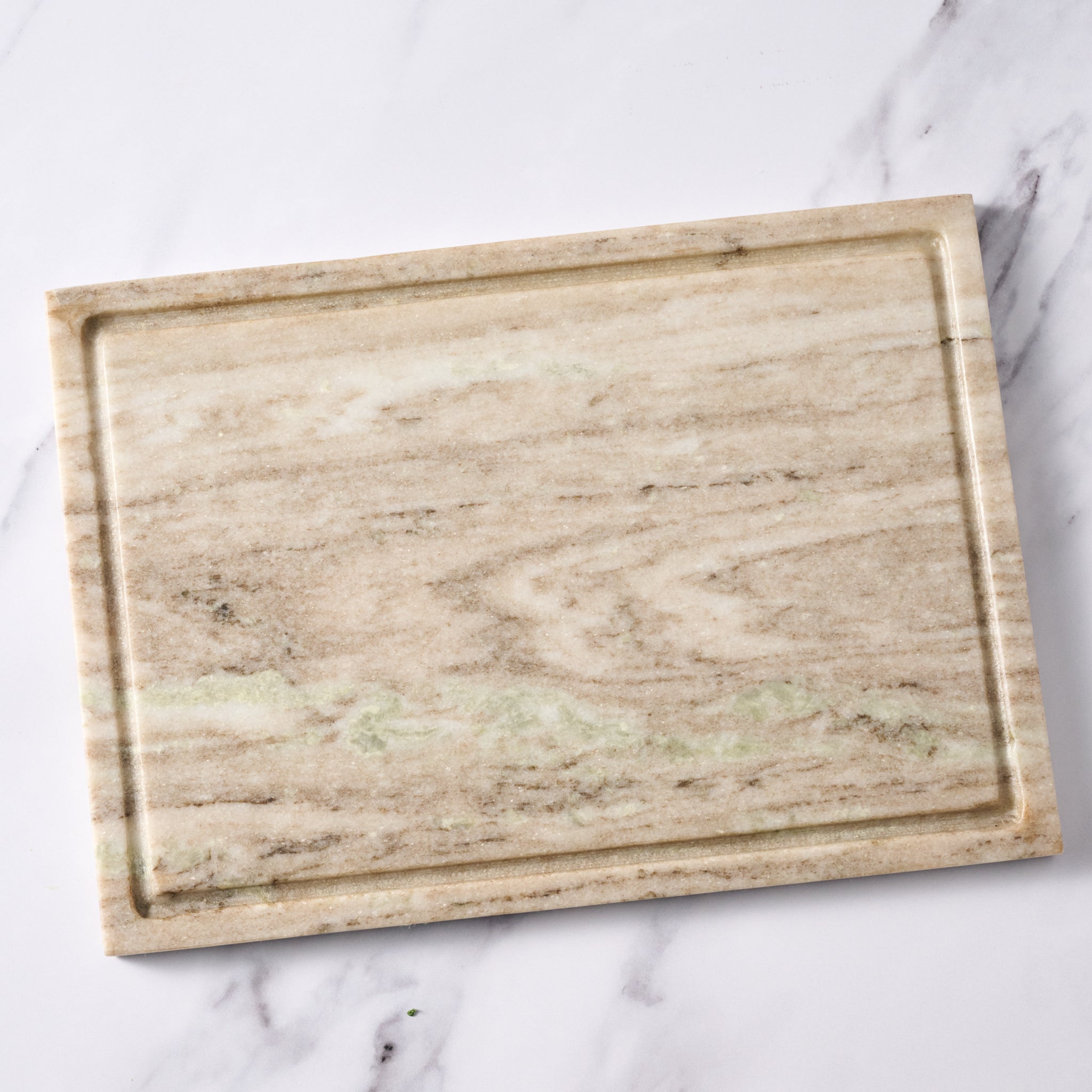 Marble-patterned cutting board on a marble surface