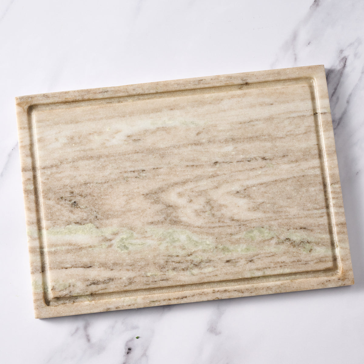 Marble-patterned cutting board on a marble surface